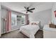 Bedroom with ceiling fan, pink curtains, a window, and white furniture at 607 Lexington Way, Woodstock, GA 30189