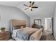 Relaxing main bedroom with vaulted ceiling, fan, neutral colors, and comfortable furnishings at 607 Lexington Way, Woodstock, GA 30189
