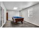 Finished game room with pool table offers space for recreation and leisure at 607 Lexington Way, Woodstock, GA 30189