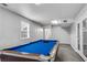 A bright game room with pool table and easy access to the outside at 607 Lexington Way, Woodstock, GA 30189