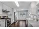 Well-lit kitchen featuring white cabinets, stainless steel appliances, and open layout at 607 Lexington Way, Woodstock, GA 30189