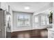 Bright kitchen features stainless steel fridge, abundant natural light, and seamless flow to the dining area at 607 Lexington Way, Woodstock, GA 30189