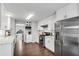 Modern kitchen boasts stainless steel appliances, ample white cabinetry and countertop space at 607 Lexington Way, Woodstock, GA 30189