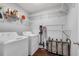 Efficient laundry room with shelving, washer, dryer and storage solutions at 607 Lexington Way, Woodstock, GA 30189