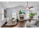 Spacious living room with a stone fireplace, hardwood floors, and vaulted ceilings at 607 Lexington Way, Woodstock, GA 30189