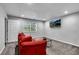 Cozy living room features a red sofa, window and mounted flat screen TV at 607 Lexington Way, Woodstock, GA 30189