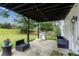 Relaxing outdoor patio with grill, furniture, and a view of the spacious, fenced backyard at 607 Lexington Way, Woodstock, GA 30189