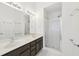 Bathroom featuring double sinks, vanity, and walk-in shower at 106 Weatherstone Square Drive, Woodstock, GA 30188