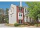 Charming home featuring brick and neutral siding, a front porch, and well-maintained landscaping at 106 Weatherstone Square Drive, Woodstock, GA 30188