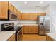 Eat-in kitchen with stainless steel appliances and wood cabinets at 106 Weatherstone Square Drive, Woodstock, GA 30188