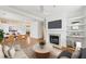 Bright, open living room with fireplace, built-in shelves, and adjacent dining area at 106 Weatherstone Square Drive, Woodstock, GA 30188