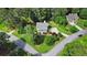Aerial view of home, surrounded by mature trees, lush green lawns, and a horseshoe driveway at 21 Picketts Ridge Ln, Acworth, GA 30101