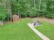 Serene backyard with a fire pit, shed, and lush green lawn, perfect for relaxation and entertaining at 21 Picketts Ridge Ln, Acworth, GA 30101