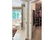 Bright bathroom with a soaking tub, open doorway to walk-in closet, and neutral color scheme at 21 Picketts Ridge Ln, Acworth, GA 30101