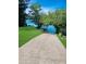 Concrete boat ramp leading into a calm lake surrounded by lush greenery and clear skies providing easy lake access at 21 Picketts Ridge Ln, Acworth, GA 30101