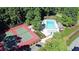 Aerial view showcasing the community pool and tennis courts surrounded by lush trees and with ample parking at 21 Picketts Ridge Ln, Acworth, GA 30101