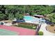 Aerial shot of a community pool, tennis court and corn hole area surrounded by lush trees and landscaping at 21 Picketts Ridge Ln, Acworth, GA 30101