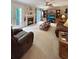 Inviting living room featuring plush seating, a fireplace, and a ceiling fan for added comfort at 21 Picketts Ridge Ln, Acworth, GA 30101