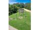 Pickett's Lake private sign near a green field surrounded by lush trees indicating the entrance to the private lake at 21 Picketts Ridge Ln, Acworth, GA 30101