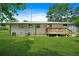 Large backyard with a well-maintained lawn and a small deck at 3839 Brookcrest Cir, Decatur, GA 30032