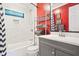Modern bathroom featuring gray vanity, stylish fixtures, bathtub, and shower at 3839 Brookcrest Cir, Decatur, GA 30032