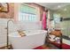 Large bathroom featuring a freestanding tub, glass shower and floral wallpaper at 3839 Brookcrest Cir, Decatur, GA 30032