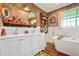 Bright bathroom featuring a freestanding tub, double sink vanity and floral wallpaper at 3839 Brookcrest Cir, Decatur, GA 30032
