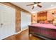 A secondary bedroom with hardwood floors, floral wallpaper and a ceiling fan at 3839 Brookcrest Cir, Decatur, GA 30032