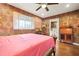 Bedroom featuring charming wallpaper, wood floors, with an ensuite bathroom at 3839 Brookcrest Cir, Decatur, GA 30032