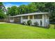 Beautiful house with a well-maintained lawn, white brick, and wood accents giving it a cozy and modern feel at 3839 Brookcrest Cir, Decatur, GA 30032