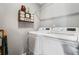 Bright laundry room with white washer and dryer and custom wall decor at 3839 Brookcrest Cir, Decatur, GA 30032
