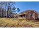 Expansive backyard features a charming brick home with a screened porch and a detached building at 410 Fitzgerald Ln, Fayetteville, GA 30215