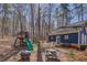Backyard featuring a playground, seating, and mature trees, offering a perfect blend of recreation and relaxation at 410 Fitzgerald Ln, Fayetteville, GA 30215
