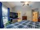 Comfortable bedroom showcasing a ceiling fan, window with view, and TV at 410 Fitzgerald Ln, Fayetteville, GA 30215