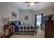 Bedroom featuring a ceiling fan, window and plaid bedding at 410 Fitzgerald Ln, Fayetteville, GA 30215