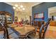Beautiful dining room with formal dark wood table, classic accents, and hardwood flooring at 410 Fitzgerald Ln, Fayetteville, GA 30215