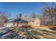Well-maintained brick house with attached garage surrounded by a spacious yard and mature trees offers suburban charm at 410 Fitzgerald Ln, Fayetteville, GA 30215