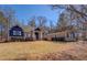 Charming two-story home featuring blue and brick accents, manicured landscaping, and inviting curb appeal at 410 Fitzgerald Ln, Fayetteville, GA 30215