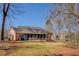 Brick house featuring a screened-in porch and a vast, well-manicured lawn, offering a blend of comfort and outdoor living at 410 Fitzgerald Ln, Fayetteville, GA 30215