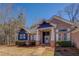 Beautiful blue and brick home with a well-manicured lawn, showcasing classic curb appeal at 410 Fitzgerald Ln, Fayetteville, GA 30215