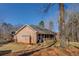 Expansive brick home with a screened-in porch, surrounded by mature trees and a well-maintained lawn for peaceful living at 410 Fitzgerald Ln, Fayetteville, GA 30215