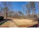 View from the porch overlooks a spacious front yard with mature trees, offering a tranquil setting at 410 Fitzgerald Ln, Fayetteville, GA 30215