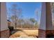 View from the porch shows the expansive front yard and mature trees, framing a serene outdoor space at 410 Fitzgerald Ln, Fayetteville, GA 30215