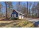 Detached two-car garage with ample driveway space situated on a landscaped lot with mature trees and manicured lawn at 410 Fitzgerald Ln, Fayetteville, GA 30215
