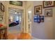 Hallway leading to bedroom, featuring framed artwork and hardwood floors at 410 Fitzgerald Ln, Fayetteville, GA 30215