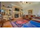 Inviting living room featuring a brick fireplace, built-in bookshelves, and hardwood floors at 410 Fitzgerald Ln, Fayetteville, GA 30215