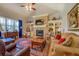 Living room showcasing a fireplace, built-in shelving, and ample seating with plenty of natural light at 410 Fitzgerald Ln, Fayetteville, GA 30215