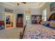 Spacious main bedroom featuring tray ceilings, neutral walls, and doorway to bath at 410 Fitzgerald Ln, Fayetteville, GA 30215