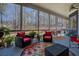 Cozy screened porch featuring comfortable seating, a patterned rug, and tranquil views of the surrounding greenery at 410 Fitzgerald Ln, Fayetteville, GA 30215
