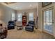 Relaxing sitting area in the main bedroom with comfortable chairs and natural light at 410 Fitzgerald Ln, Fayetteville, GA 30215